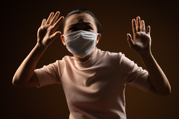 Obraz premium Don't touch me. Asian woman wearing protective face mask panic disgusted standing isolated on beige background.
