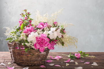 flowers in basket on old wooden table