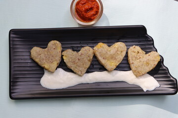 Sabudana vada or wada, sabu vada, traditional deep fried snack made with tapioca balls from Maharashtra, India, served with curd 