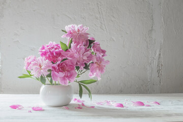 pink  peonies  on background old white wall