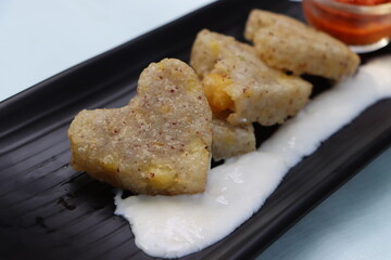 Sabudana vada or wada, sabu vada, traditional deep fried snack made with tapioca balls from Maharashtra, India, served with curd 