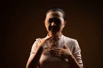 Fototapeta na wymiar Asian woman was sick with sore throat standing isolated on beige background.