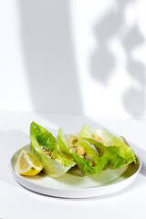 Homemade Caesar salad with chicken, lettuce, lemon, toast, cesar sauce, cheese and garlic