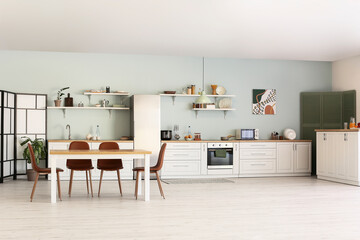 Stylish interior of modern kitchen with dining table