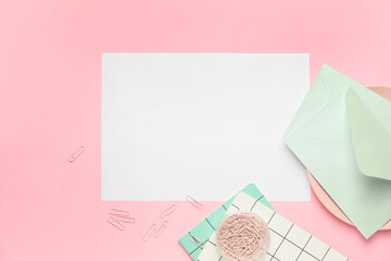 Blank card with envelopes and stationery on color background