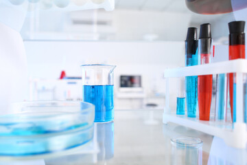 Glassware with samples on shelf in laboratory
