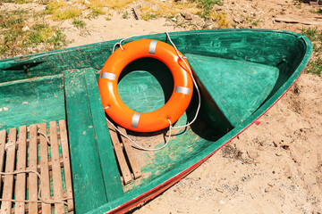 Boat with lifebuoy ring on coast