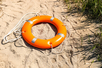 Bright lifebuoy ring on beach