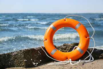 Bright lifebuoy ring on beach