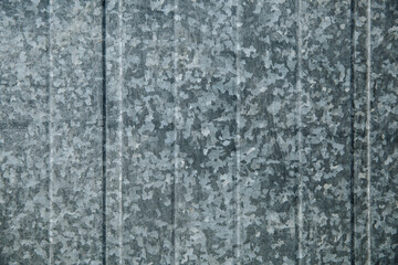 Tin fence with a beautiful textured pattern.