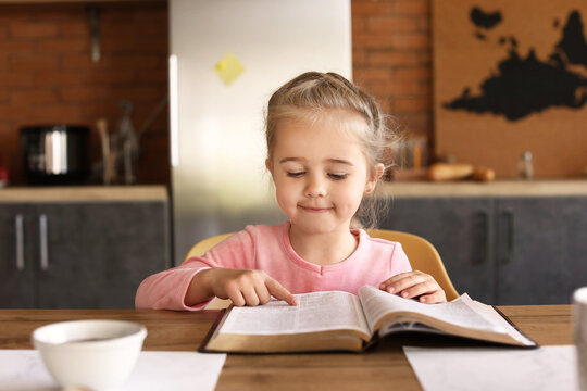 Little Girl Reading Bible At Home