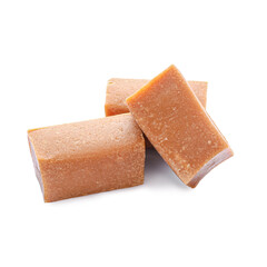 Tasty caramel candies on white background