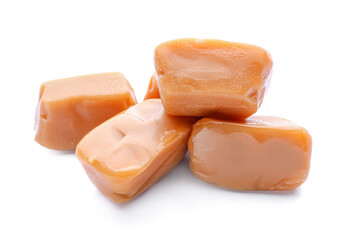 Tasty caramel candies on white background