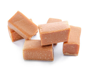Tasty caramel candies on white background