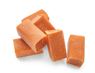 Tasty caramel candies on white background
