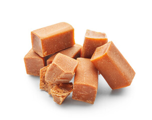 Tasty caramel candies on white background