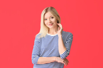 Portrait of beautiful young woman on color background