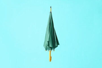 Stylish umbrella on color background