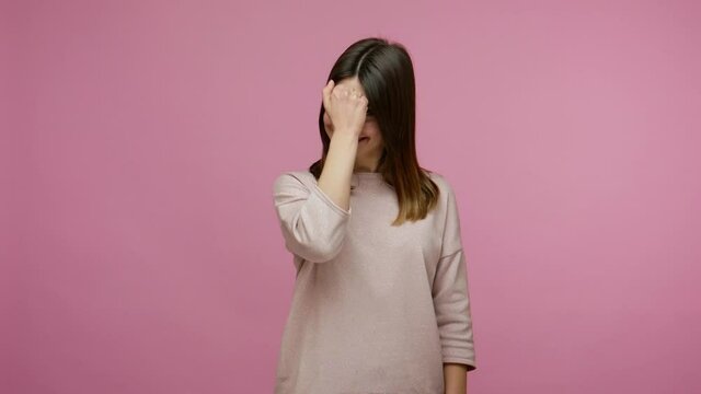 Hearing loss. Positive woman communicating with deaf-mute sign language, making fingers shape saying nonverbal phrase Hi, how are you? I'm fine thanks. indoor studio shot isolated on pink background