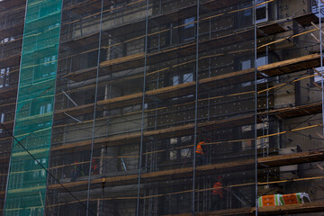 Obraz na płótnie Canvas builders are building a multi-storey house. scaffolding and materials
