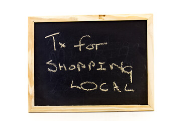 Fototapeta premium Small blackboard with a message to support small local business during the lockdown for covid-19 isolated on a clear background with copy space