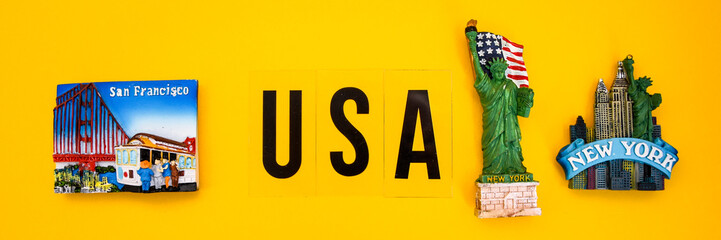 word USA with magnets from new york and san francisco on yellow background, travel destination