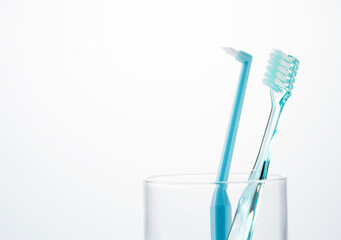Toothbrush in a cup on a white background