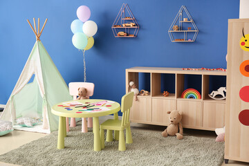 Stylish interior of modern playroom in kindergarten