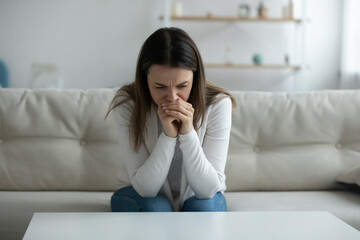 Woman feels depressed hopeless crying sit on sofa, upset female victim in trouble being offended abused, unplanned pregnancy and heavy decision about abortion, alcohol addiction need rehab aid concept - obrazy, fototapety, plakaty
