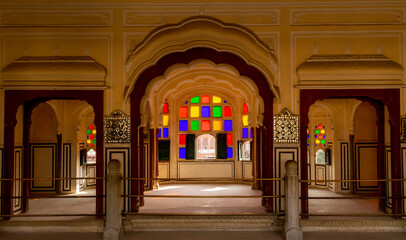 Jaipur, Rajasthan, India; Feb, 2020 : colourful tinted glass design around windows at the Hawa...
