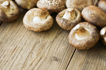 Fresh mushrooms on wooden table background - Shiitake mushrooms