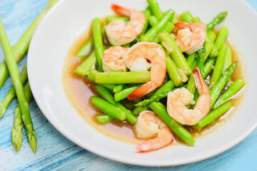 Asparagus Shrimp Seafood Cooked Health Food - Stir fried shrimps with asparagus green on white plate and wooden table background