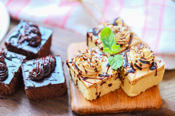 Coffee cake topping chocolate delicious sweet dessert served on the table - cake chocolate slice on wooden with mint leaf for breakfast