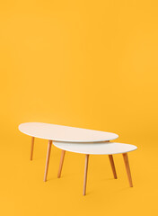 Stylish tables on color background