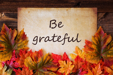 Grungy Old Paper With English Text Be Grateful. Colorful Autum Decoration With Leaves
