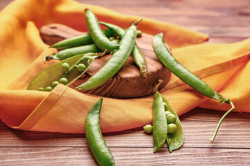 Board with tasty fresh peas on table