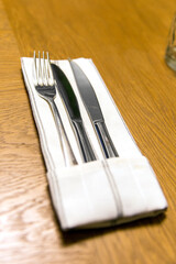 Two knife and fork on a white napkin, closeup