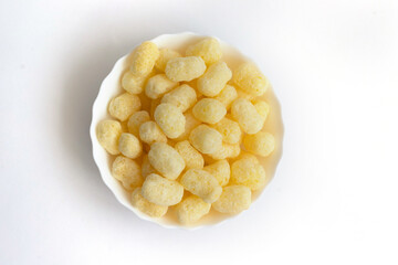 Corn sticks in a white plate. A light, delicious snack. Corn products.
