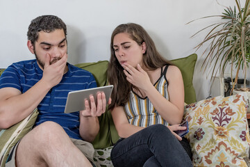 Shocked couple watching online content