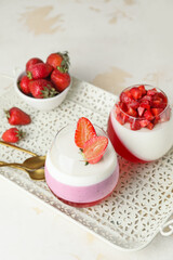 Tasty strawberry dessert in glasses on tray