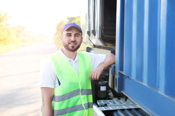 Male driver near big truck outdoors