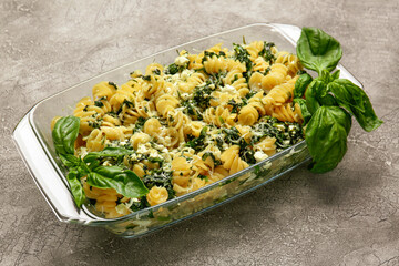 Tasty baked pasta in dish on grey background