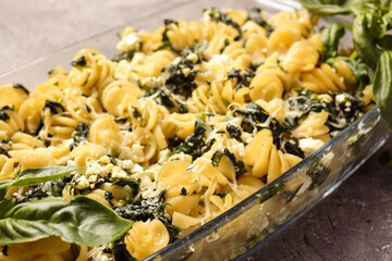 Tasty baked pasta in dish on grey background, closeup