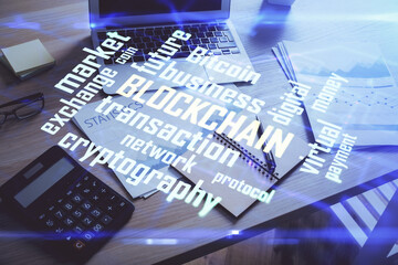 Double exposure of blockchain and crypto economy theme hologram and table with computer background. Concept of bitcoin cryptocurrency.