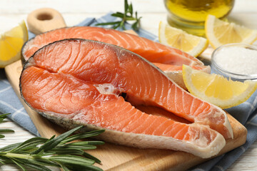 Composition with salmon meat and spices on wooden background, close up