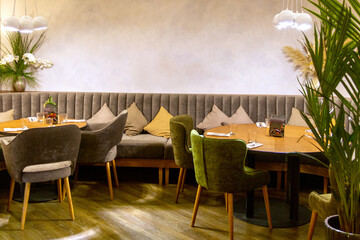 Interior of cozy modern restaurant with soft sofas and armchairs