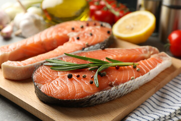 Composition with salmon meat and ingredients for cooking on gray table