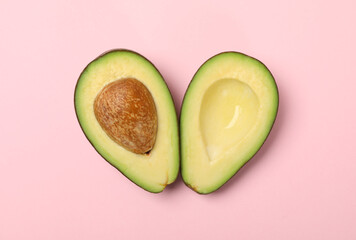 Ripe fresh avocado on pink background, top view