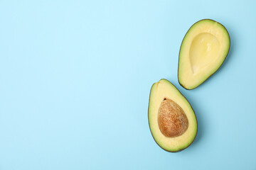 Ripe fresh avocado on blue background, top view