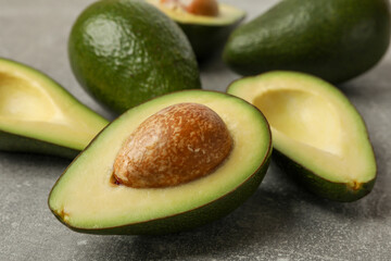 Ripe fresh avocado on gray background, close up